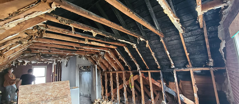 Fire-damaged home restoration, smoke damage cleanup process, before and after fire restoration in Michigan